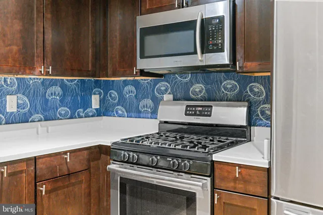 a kitchen with stove and cabinets