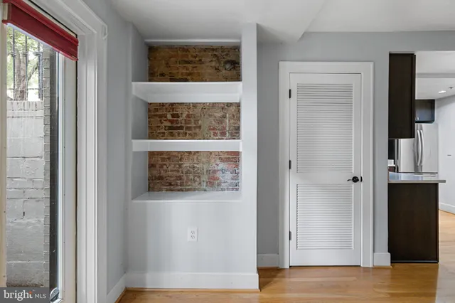 a view of hallway with wooden floor