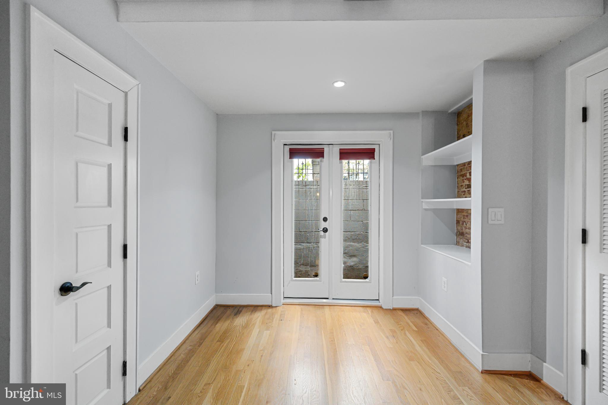 1109 M Street Northwest, Unit 1 Washington, DC 20005 - Photo 9 of 32 a view of an empty room with wooden floor and a window