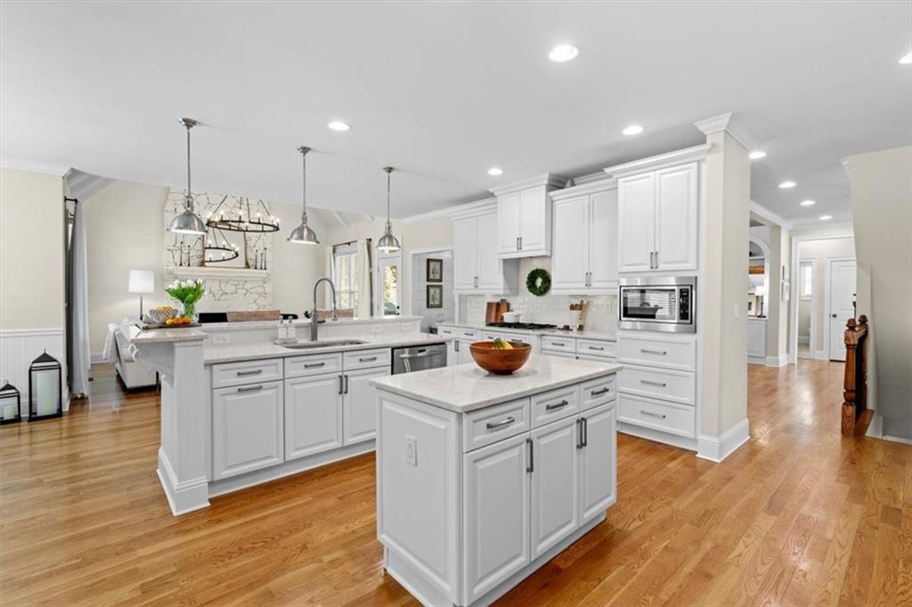 1002 Tyle Street Northwest Kennesaw, GA 30152 - Photo 23 of 83 a kitchen with white cabinets and stainless steel appliances