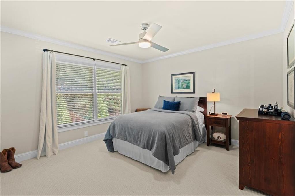 1002 Tyle Street Northwest Kennesaw, GA 30152 - Photo 46 of 83 a spacious bedroom with a bed and a dresser next to a window