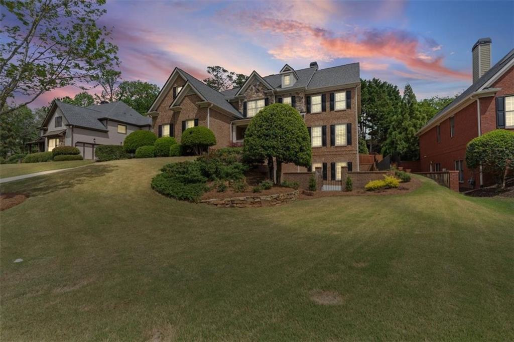 1002 Tyle Street Northwest Kennesaw, GA 30152 - Photo 5 of 83 a front view of a house with a garden