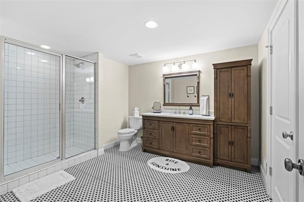 1002 Tyle Street Northwest Kennesaw, GA 30152 - Photo 53 of 83 a bathroom with a sink a toilet and shower