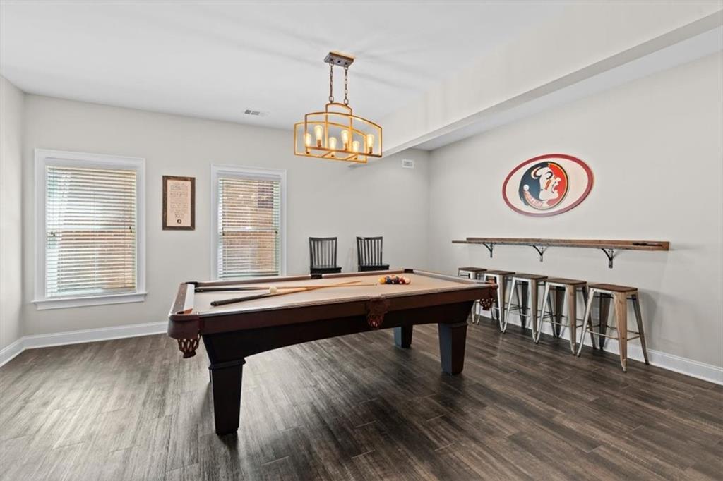 1002 Tyle Street Northwest Kennesaw, GA 30152 - Photo 59 of 83 a room with a table chairs and wooden floor
