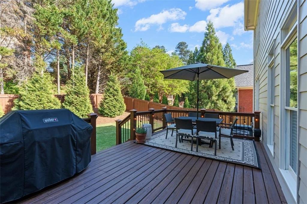 1002 Tyle Street Northwest Kennesaw, GA 30152 - Photo 66 of 83 a view of a chairs and table on the wooden roof deck