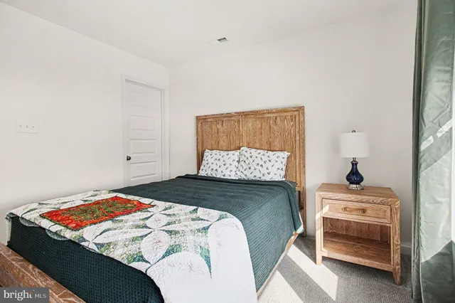 a bedroom with a bed and dresser