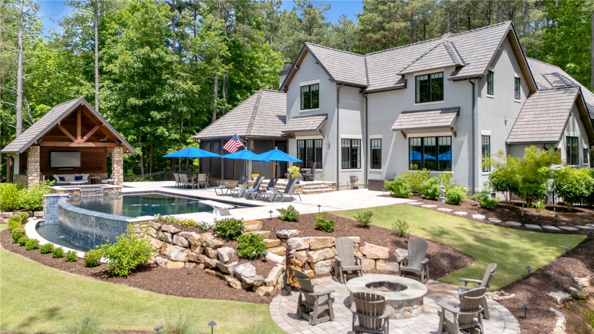 119 Drewberry Lane Sunset, SC 29685 - Photo 2 of 42 This grand residence features a private pool, an outdoor living space, and a charming fire pit area.