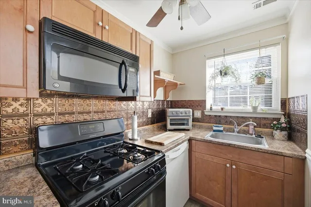 a kitchen with stainless steel appliances a stove sink and cabinets
