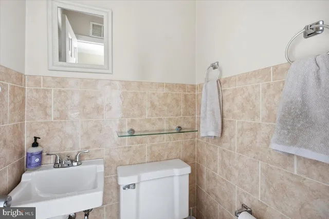 a bathroom with a sink a toilet and mirror