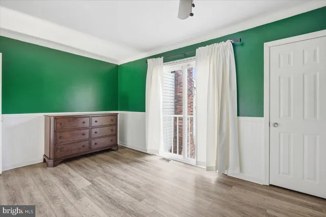 an empty room with windows and closet