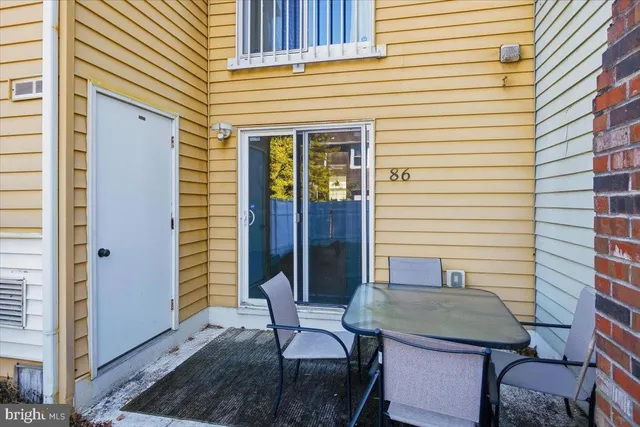 a balcony with table and chairs