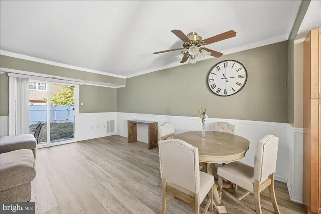 a living room with furniture a clock and a window