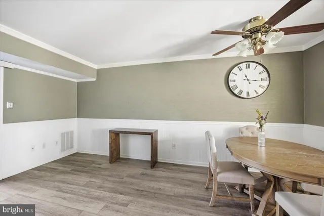 a view of a kitchen that has a table and a chair in it
