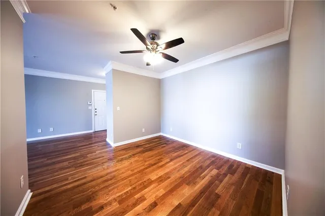 a view of an empty room with wooden floor