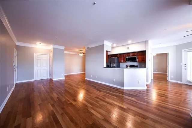a view of a hallway with wooden floor