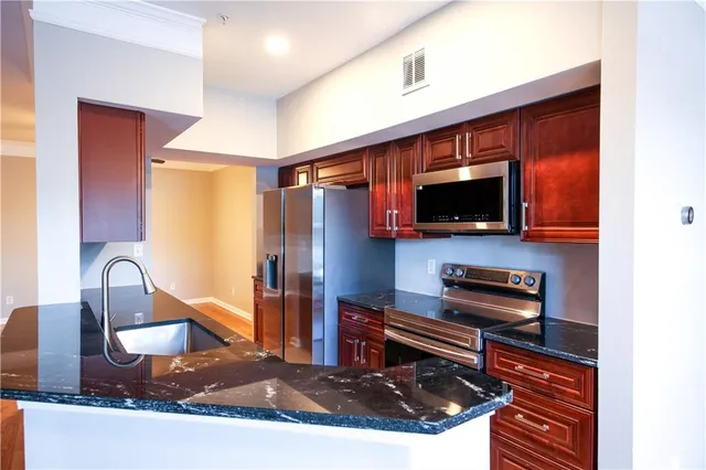 a kitchen with a appliances a sink and a microwave