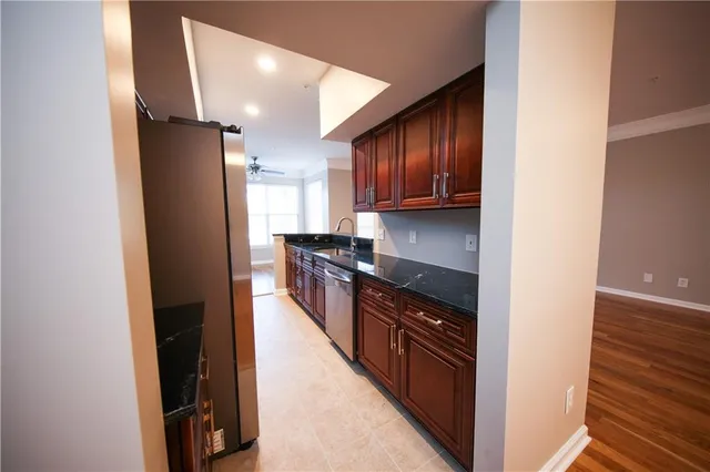 a kitchen with stainless steel appliances granite countertop a refrigerator and a sink
