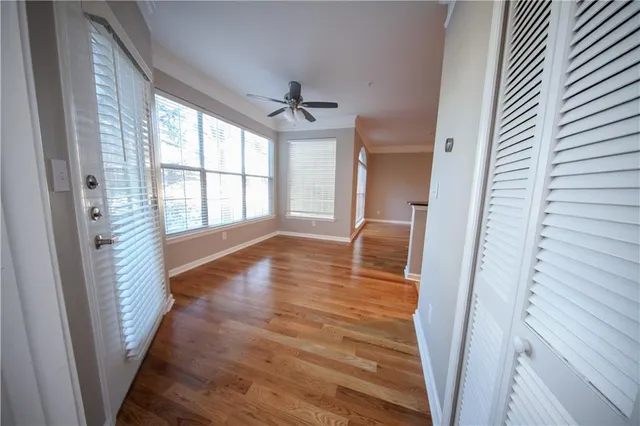 a view of a hallway view with wooden floor and staircase