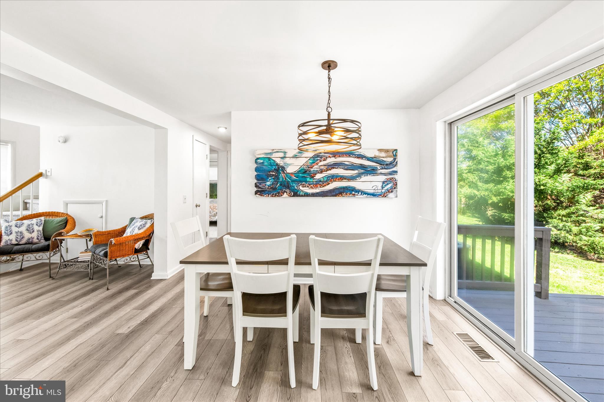 21406 Dogwood Cove Road Tilghman, MD 21671 - Photo 24 of 68 a view of a dining room with furniture a chandelier and wooden floor