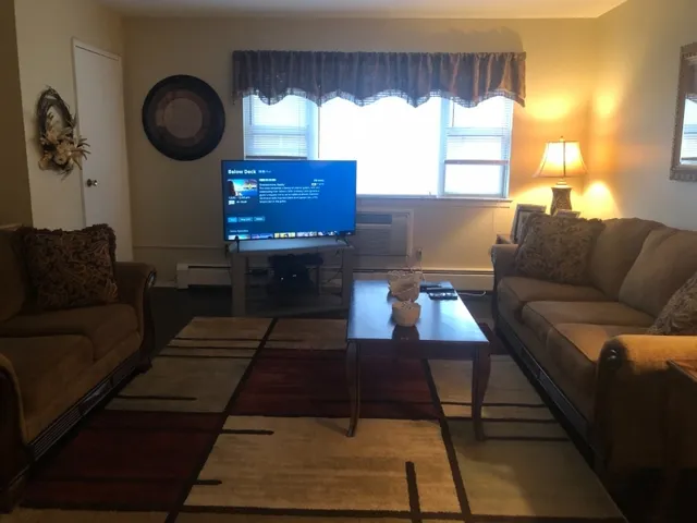 a living room with furniture and a large window