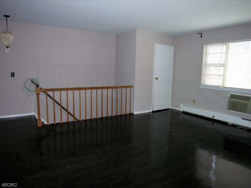 1143 Valley Road, Unit 1143 Wayne, NJ 07470 - Photo 13 of 25 a view of a hallway with wooden floor and a window