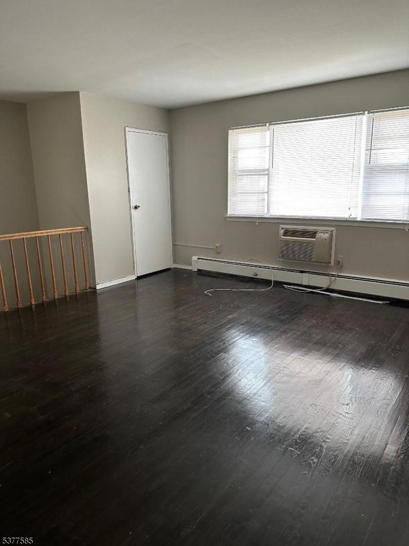 1143 Valley Road, Unit 1143 Wayne, NJ 07470 - Photo 14 of 25 a view of an empty room with wooden floor and a window