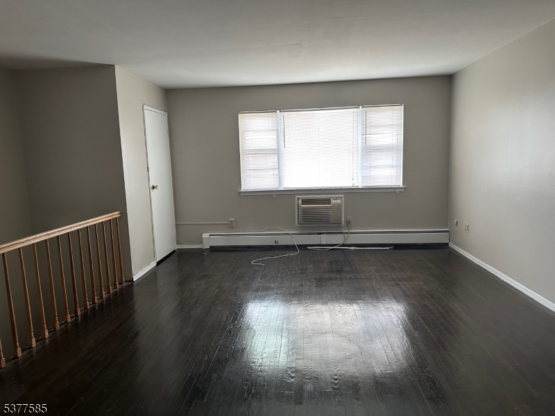 1143 Valley Road, Unit 1143 Wayne, NJ 07470 - Photo 15 of 25 an empty room with wooden floor and windows
