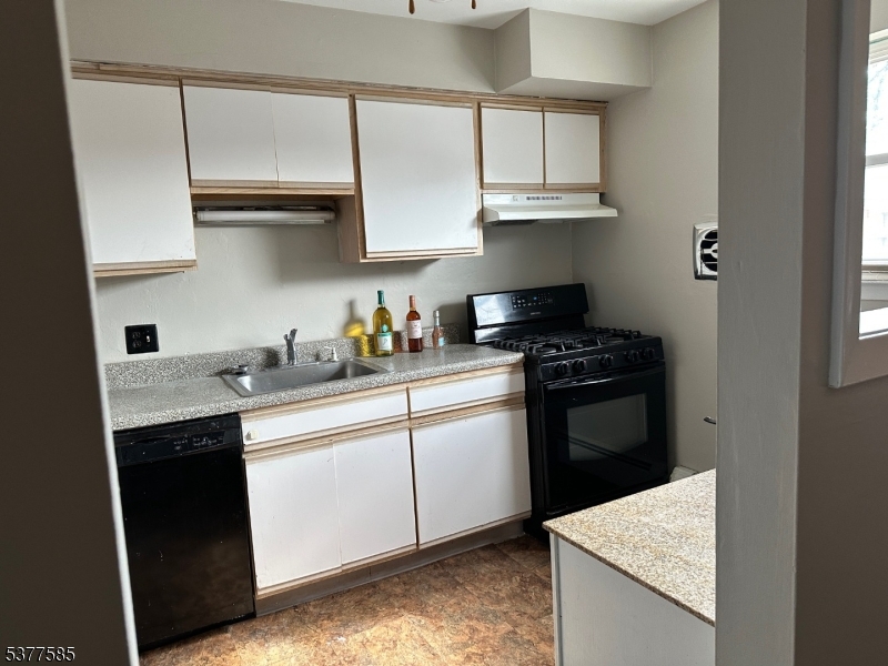 1143 Valley Road, Unit 1143 Wayne, NJ 07470 - Photo 3 of 25 a kitchen with stainless steel appliances granite countertop a sink stove and cabinets