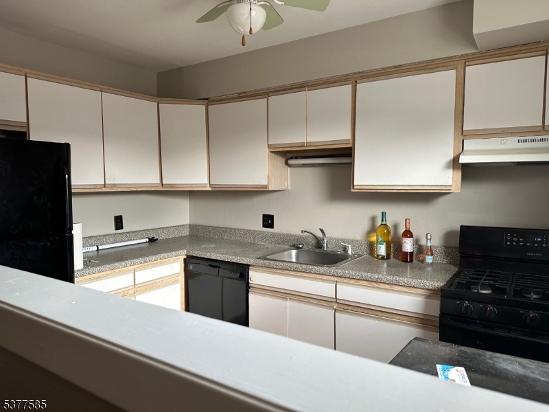 1143 Valley Road, Unit 1143 Wayne, NJ 07470 - Photo 4 of 25 a kitchen with stainless steel appliances granite countertop a sink stove and refrigerator