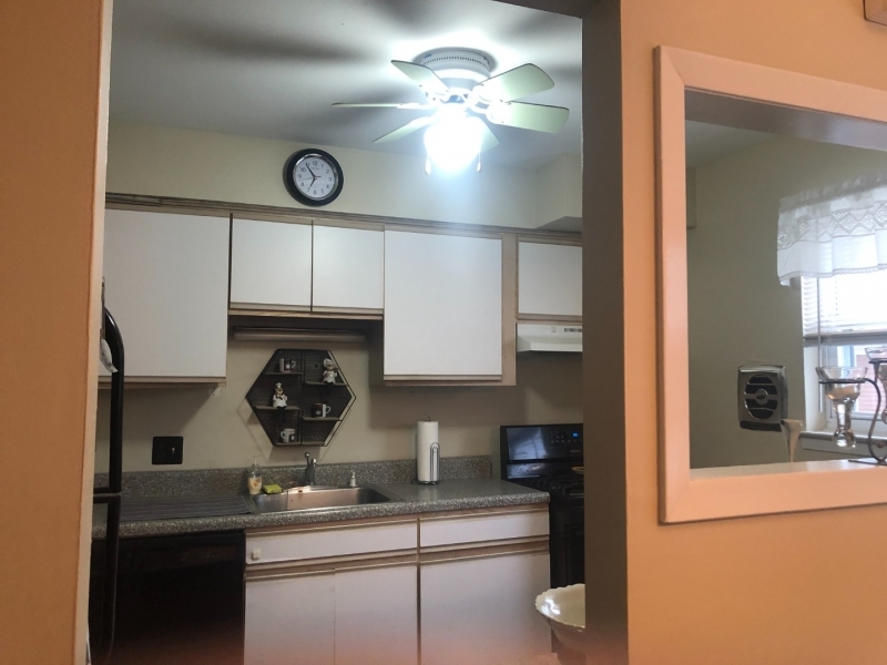 1143 Valley Road, Unit 1143 Wayne, NJ 07470 - Photo 5 of 25 a kitchen with stainless steel appliances granite countertop a sink and cabinets