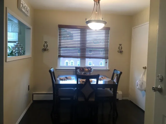 a view of a dining room with furniture and window