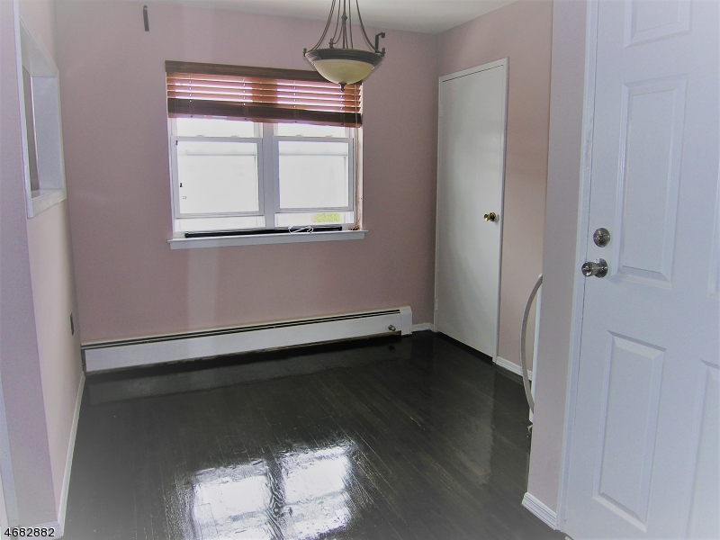 1143 Valley Road, Unit 1143 Wayne, NJ 07470 - Photo 9 of 25 an empty room with wooden floor and windows