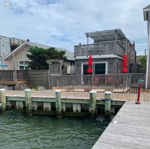 a view of house with swimming pool and seating area