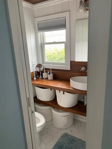 a bathroom with a toilet sink and mirror