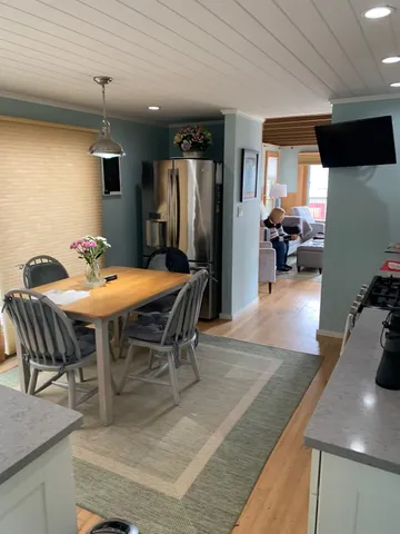 a outdoor dining space with furniture and a view of kitchen