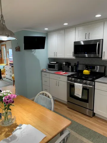 a kitchen with a sink a stove and cabinets