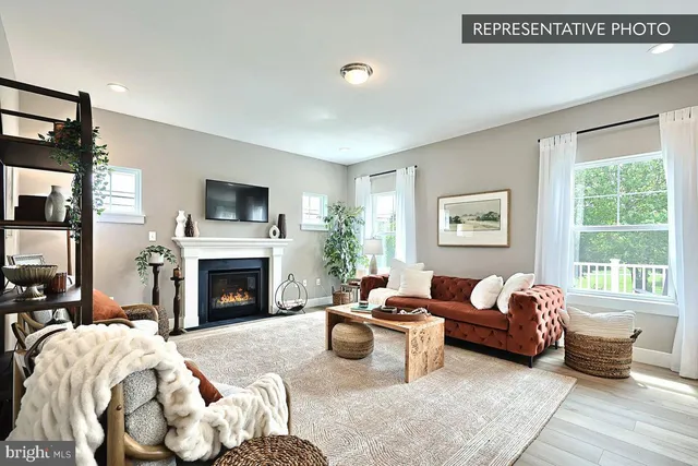 a living room with furniture large window and a fireplace