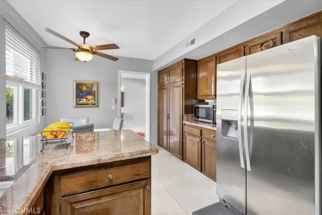 a kitchen with granite countertop cabinets and refrigerator
