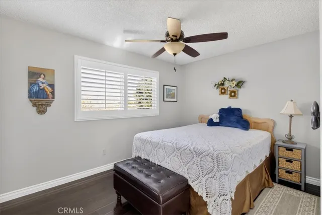 a view of a workspace with furniture and a ceiling fan