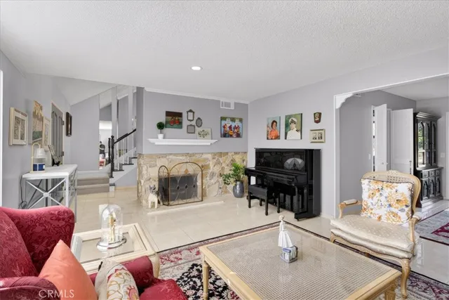 a living room with furniture a fireplace and a flat screen tv