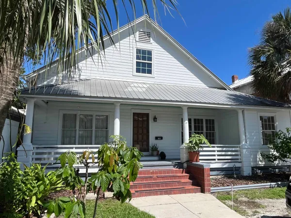 a front view of house with yard and outdoor seating