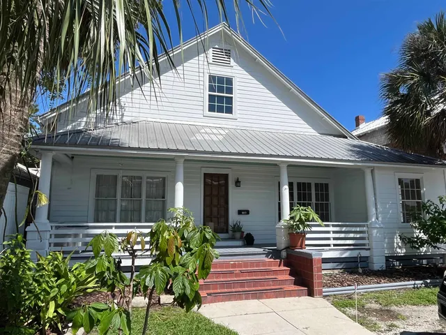 a front view of house with yard and outdoor seating
