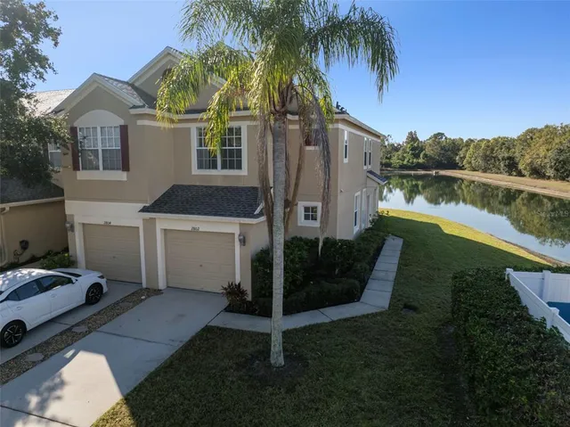 a aerial view of a house with swimming pool and lake view