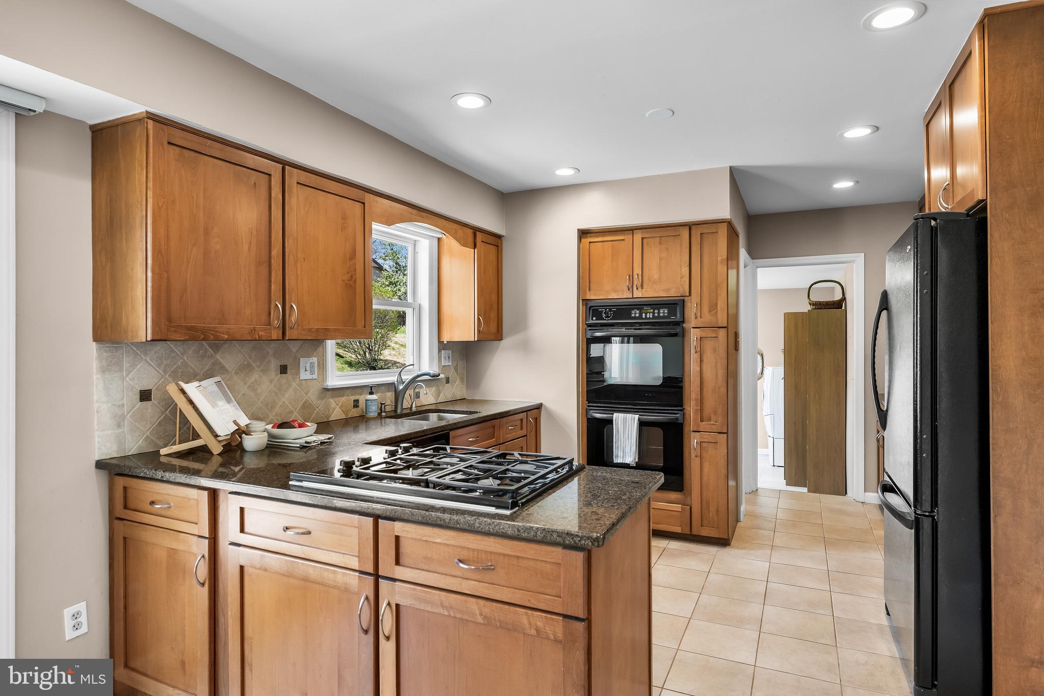 1003 Roumfort Avenue Cherry Hill, NJ 08034 - Photo 13 of 37 a kitchen with stainless steel appliances granite countertop a stove and a refrigerator
