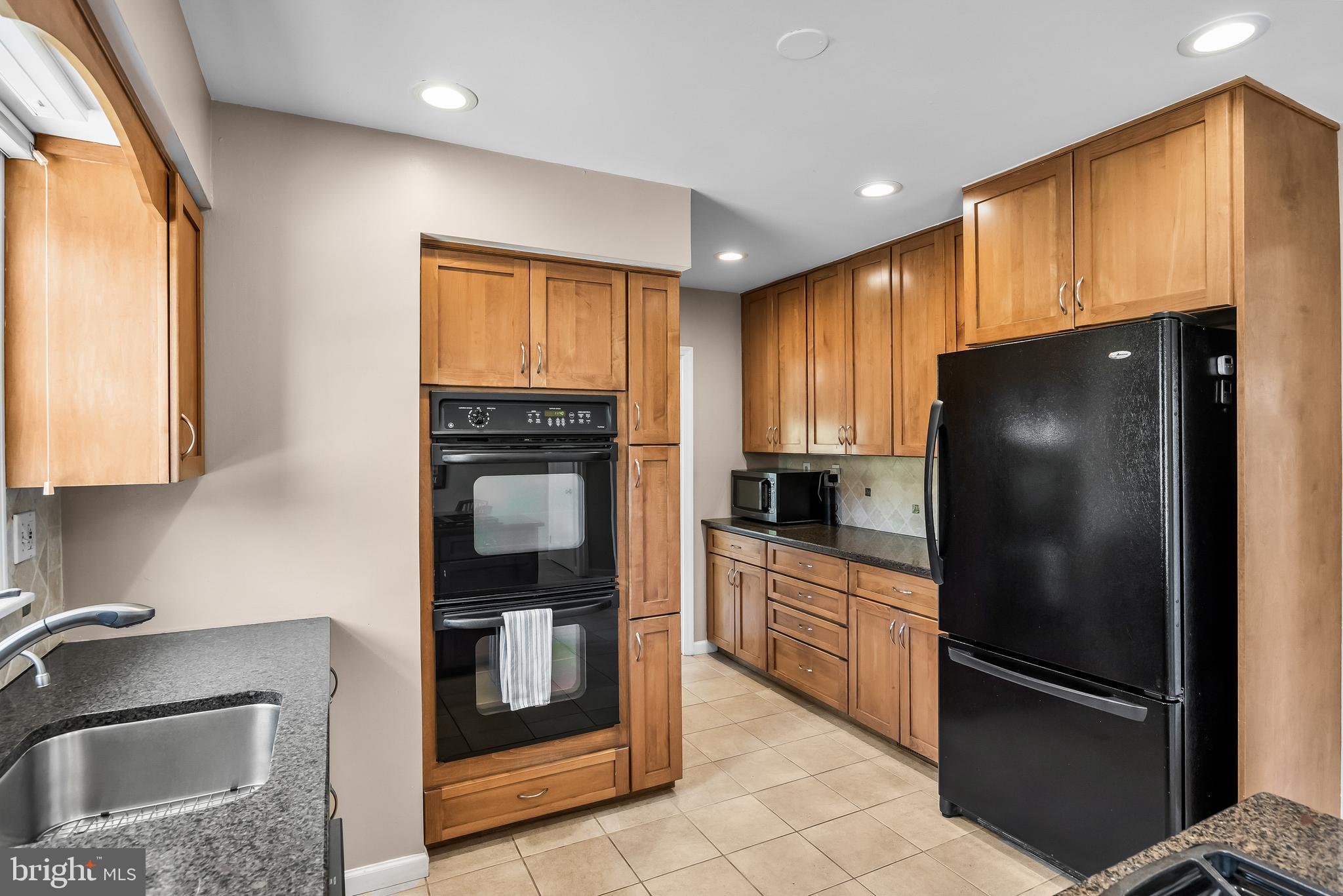 1003 Roumfort Avenue Cherry Hill, NJ 08034 - Photo 15 of 37 a kitchen with stainless steel appliances granite countertop a refrigerator and a sink