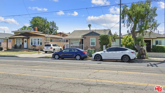 a view of a cars park in front of a building