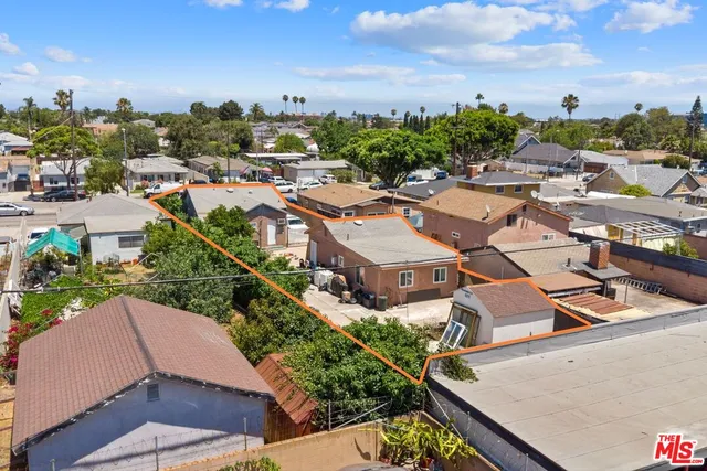 an aerial view of residential houses with outdoor space