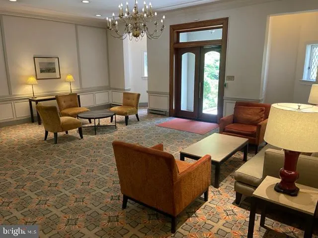 a living room with furniture a table and window