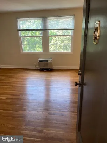a view of a room with wooden floor and window