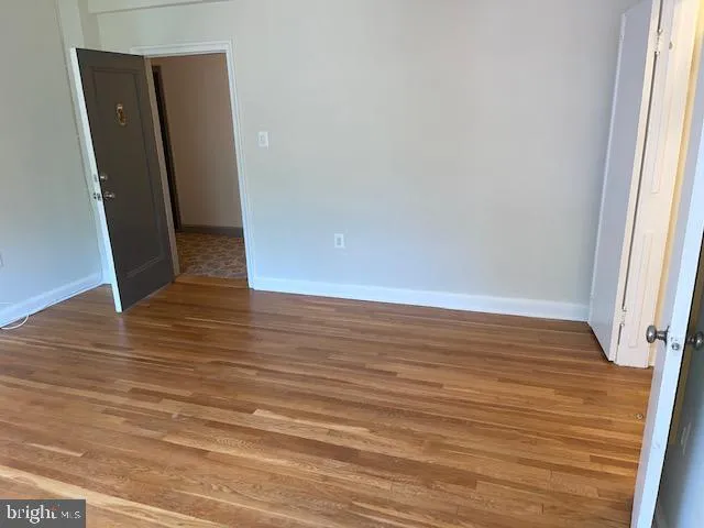 a view of room with window and wooden floor